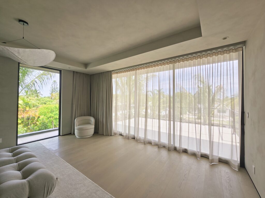 Custom motorized sheer drapery and tailored blackout window treatments by Magy Interiors