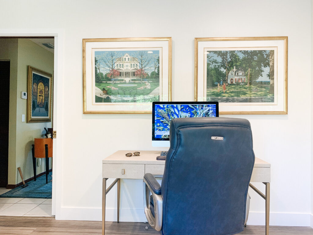 Complete home office renovation featuring a custom desk, executive leather armchair, and curated wall art for a multi-functional office and den.