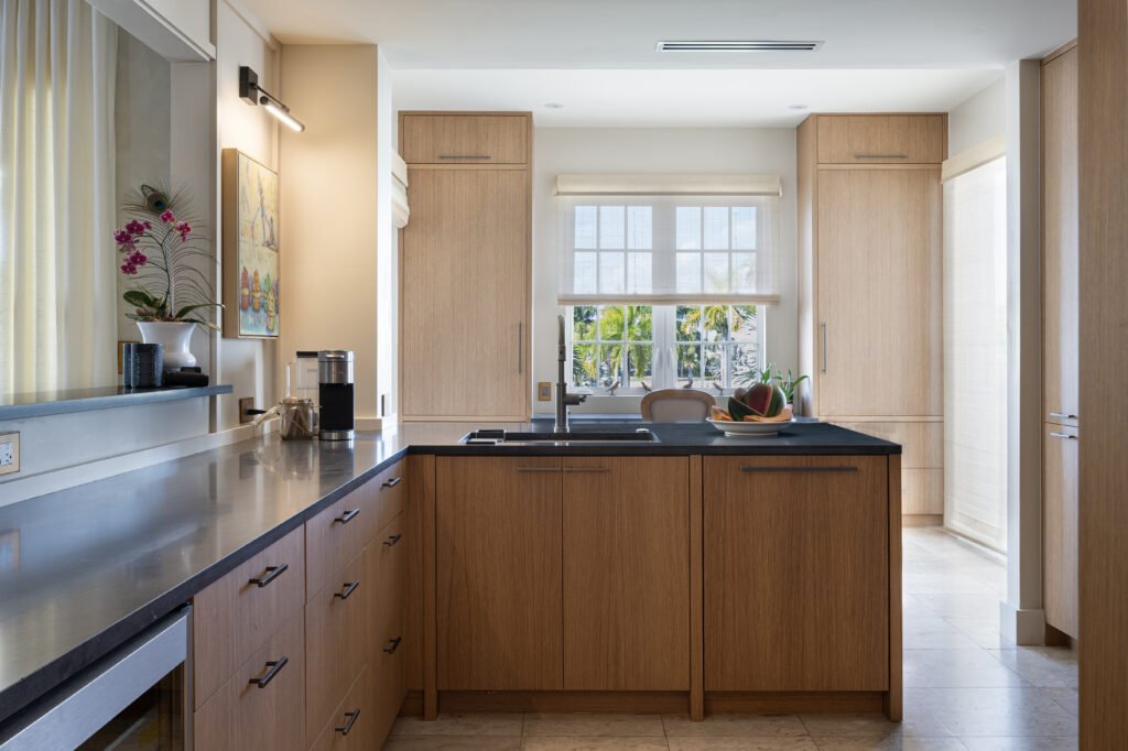 Bespoke light wood kitchen cabinetry and custom window finishes in Miami