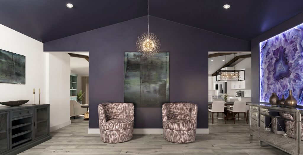 Forward-thinking monochromatic room design featuring bold color-drenched walls, curved armchairs, and refined contemporary art.