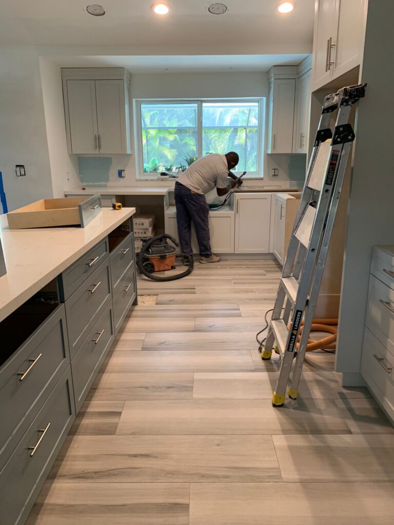 Skilled craftsman executing custom cabinetry installation on site.