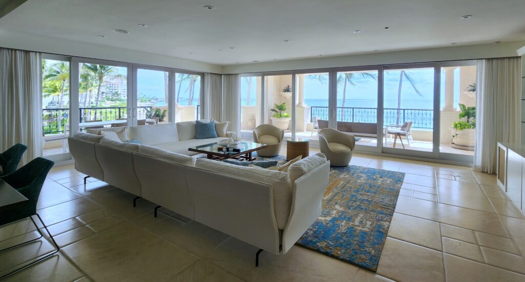 Modern coastal living room renovation featuring floor-to-ceiling ocean views.
