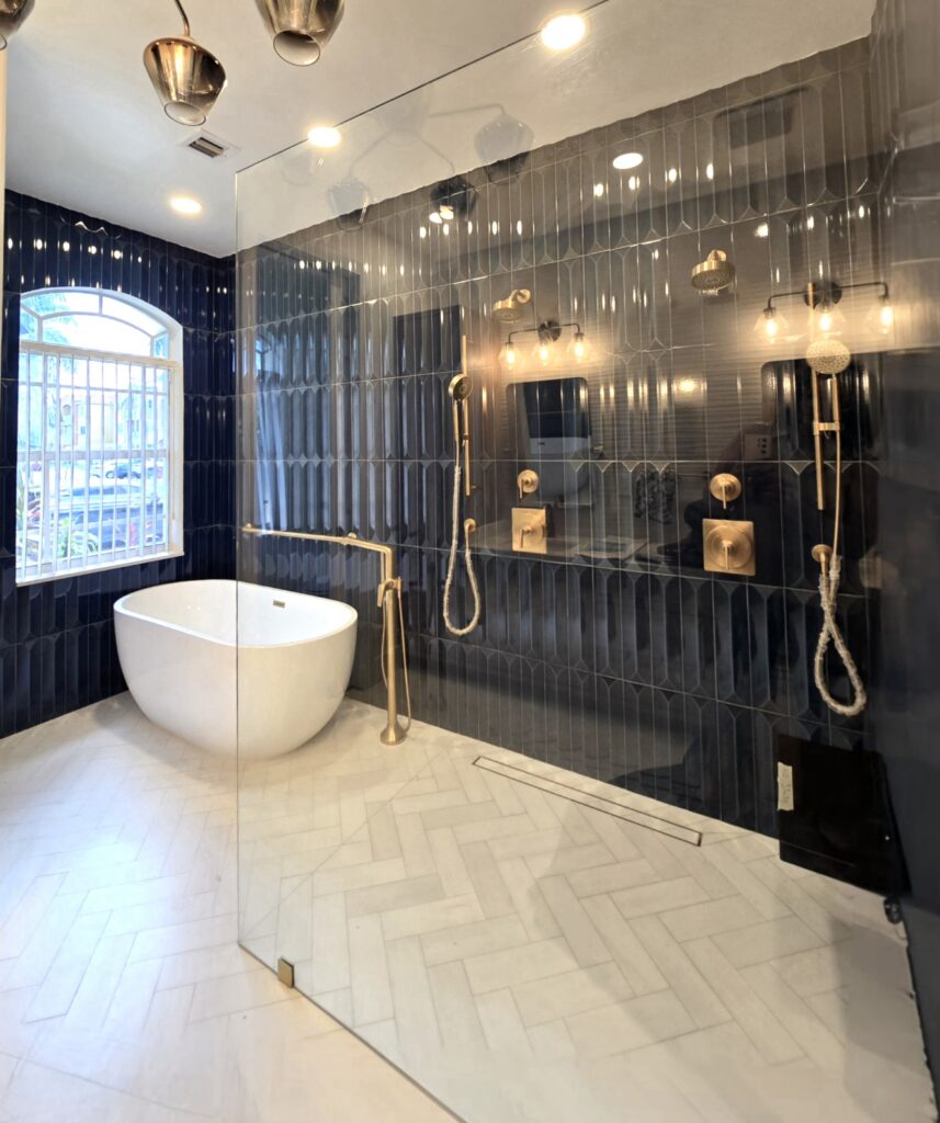 Luxury navy blue tiled bathroom suite with brass fixtures and walk-in shower